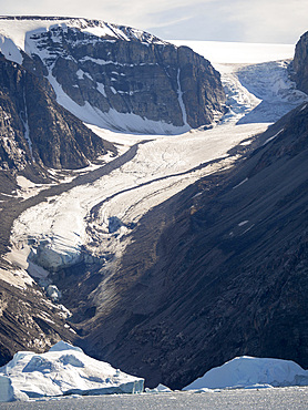 Iceberg in the Uummannaq Fjord System. Glaciated Nuussuaq peninsula in the background. America, North America, Greenland, Denmark