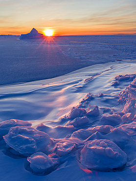 Sunset at the shore of frozen Disko Bay. Disko Bay during winter, West Greenland. America, North America, Greenland, Denmark