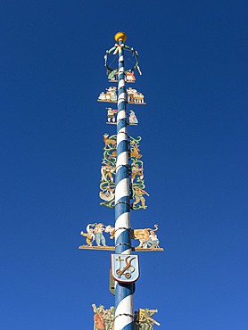 Traditional bavarian maypole (Maibaum). Village Schliersee in the bavarian Alps. Europe, Central Europe, Bavaria, Germany