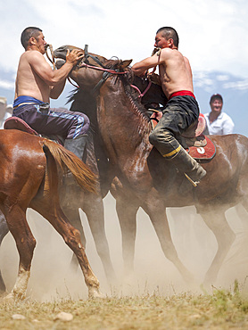 Er Enish or Oodarysh, wrestling from horseback, a traditional equestrian sport. Folk and Sport festival on the Suusamyr plain commemorating Mr Koshomkul, a sportsman and folk hero of the last century. Asia, central Asia, Kyrgyzstan