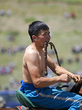 Portrait of a competitor. Er Enish or Oodarysh, wrestling from horseback, a traditional equestrian sport. Folk and Sport festival on the Suusamyr plain commemorating Mr Koshomkul, a sportsman and folk hero of the last century. Asia, central Asia, Kyrgyzstan