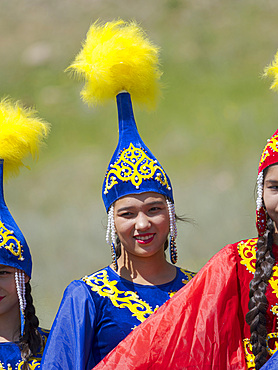 Girls of folk music band posing for visitors and photographers. Folk and Sport festival on the Suusamyr plain commemorating Mr Koshomkul, a sportsman and folk hero of the last century. Asia, central asia, Kyrgyzstan