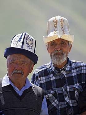 Man with traditional white felt hat, Kalpak. Folk and Sport festival on the Suusamyr plain commemorating Mr Koshomkul, a sportsman and folk hero of the last century. Asia, central asia, Kyrgyzstan