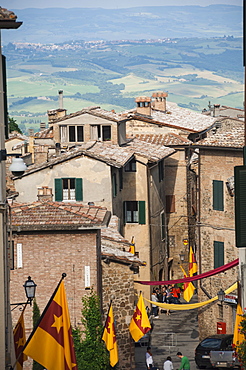 Medieval street decorated with local area flags, Montalcino, UNESCO World Heritage Site, Val d'Orcia, Tuscany, Italy, Europe