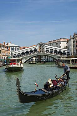 Water bus and gondola on the Grand Canal with the Rialto Bridge in the background, Venice, UNESCO World Heritage Site, Veneto, Italy, Europe