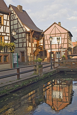 Original timber framed houses reflected in the mill race, Anweiler, Rheinland-Pfalz wine area, Germany, Europe