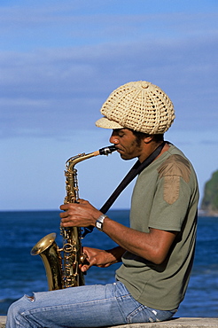 Sylvere Taverny playing a saxophone at Grand Riviere fishing village in the norther tip of the island, Martinique, Lesser Antilles, West Indies, Caribbean, Central America