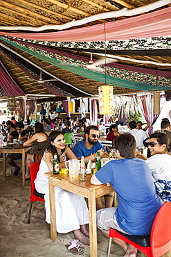 People sitting at La Plage restaurant in Ashvem, Goa, India, Asia