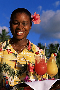 Waitress holding a tray of punch drinks, Marigot Bay, St. Lucia, Windward Islands, West Indies, Caribbean, Central America