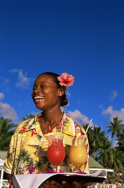 Waitress holding a tray of punch drinks, Marigot Bay, St. Lucia, Windward Islands, West Indies, Caribbean, Central America