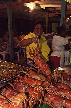 Local woman selling lobsters at the Seafood Friday night, Anse La Raye, St. Lucia, Windward Islands, West Indies, Caribbean, Central America