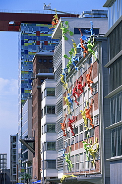 Flossies figures covering a building facade at the Medienhafen (Media Harbour), Dusseldorf, North Rhine Westphalia, Germany, Europe