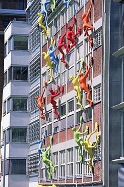 Flossies figures covering a building facade at the Medienhafen (Media Harbour), Dusseldorf, North Rhine Westphalia, Germany, Europe