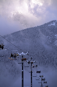 Chair lift filled with skiers and snowboarders, Mount Baker, Cascade Mountains, Washington State, United States of America (U.S.A.), North America