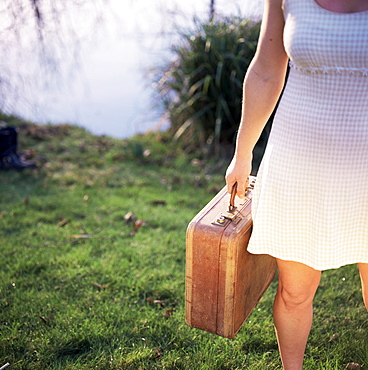 Woman with suitcase packed and ready to go