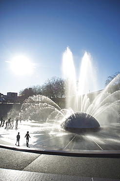 Silhouette of children playing in water fountain, Seattle Center, Seattle, Washington, United States of America, North America