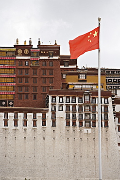 The red flag of China flies in front of the Potala Palace, UNESCO World Heritage Site, Lhasa, Tibet, China, Asia