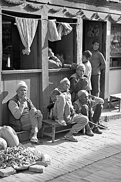 Old men and boys outside a cafe, Bhaktapur, Kathmandu valley, Nepal, Asia