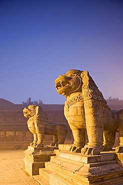 Stone lions, Durbar Square, Bhaktapur, Kathmandu valley, Nepal. Foggy winter dawn, november 2005.