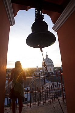 Woman takes in view from the Merced bell tower in Granada, Nicaragua, Central America