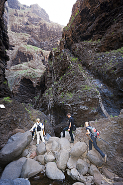 Tourists hiking through Masca Gorge, Tenerife, Canary Islands, Spain