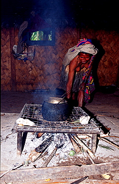 Huli woman cook in her hut, Papua New Guinea, Tari, Huli, Highlands