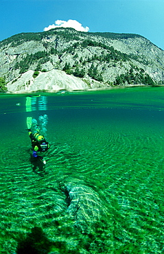 Scuba diver in mountain lake, split image, Austria, Steiermark, Gruener See