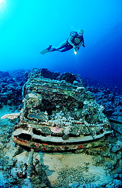 Scuba diver and car wreck near Blue Belt shipwreck, Sudan, Red Sea, Africa