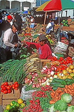 Otavalo, north of Quito is one of Latin Am's most famous markets for textiles, crafts and produce vendors in the produce market, Quito, Ecuador