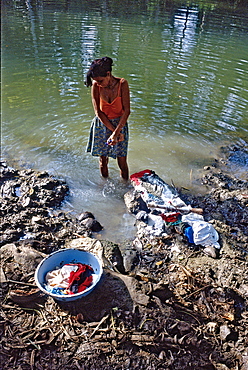 A woman washing clothes in the Rio Mata near the town of Baracoa in eastern Cuba, Cuba