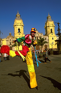 Street entertainers on stilts perform in the Plaza de Armas with the Cathedral, built in 1564-1625, (rebuilt in the 18thc) beyond, Colonial Architecture, Lima, Peru