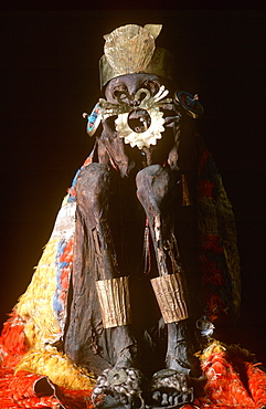 Precolumbian Gold Nazca Culture, 100-700AD mummy with gold ornaments and wrapped in feather blanket in collection of the Museo del Oro, Lima, Peru