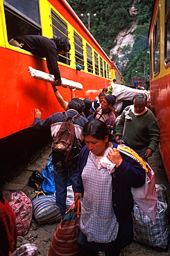 Machu Picchu the train from Cuzco arrives in Aguas Calientes the town and railroad station below site passengers unloading supplies, Highlands, Peru