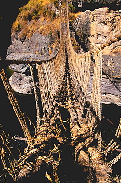 Famous Incan grass-rope suspension bridge across Apurimac River rebuilt annually since Incan period and only one still in existence, Inca Road, Altiplano, Peru