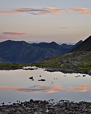 Pink clouds at dawn reflected in a tarn near Stony Pass, San Juan National Forest, Colorado, United States of America, North America