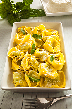 Spinach and ricotta filled ravioli with butter, sage and parmesan, Italian cooking, Italy, Europe