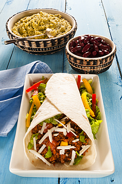 Minced meat Taco in flour Tortilla with guacamole and beans, Mexico, North America