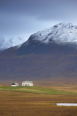 Laekjamdt farm, snow-covered Vididalsfjall mountain behind, near Blonduos, north coast, Iceland, Polar Regions