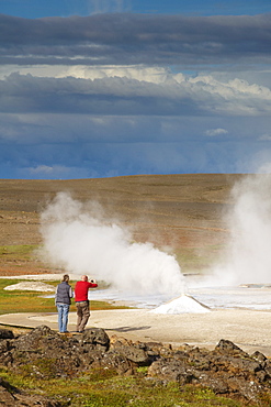 Tourists taking pictures of Oskurholshver (screaming spring), famous hot spring at Hveravellir, Kjolur, Iceland, Polar Regions