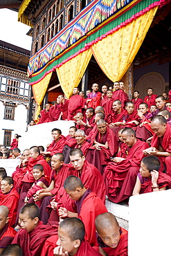 Monks watching religious dances, Buddhist festival (Tsechu), Trashi Chhoe Dzong, Thimphu, Bhutan, Asia