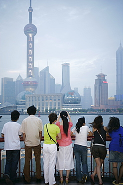 People on the Bund looking at the Oriental Pearl Tower in Pudong District, Shanghai, China, Asia