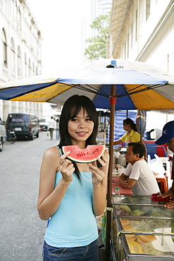 Thai woman with a slice of water melon, Bangkok,Thailand, Southeast Asia, Asia