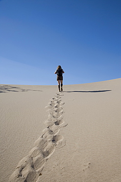 Woman trekking, Sand Dunes Point, Death Valley National Park, California, United States of America, North America