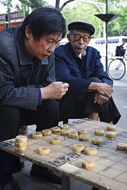 Playing Xiangqi, Chinese Chess, on the streets of Beijing, China, Asia