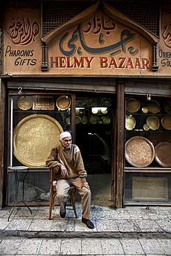 Shop owner relaxes in the great bazaar of Khan al-Khalili, Cairo, Egypt, Africa