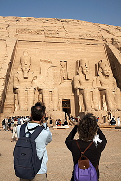 Tourists take photographs at the Great Temple of Abu Simbel, UNESCO World Heritage Site, Nubia, Egypt, North Africa, Africa