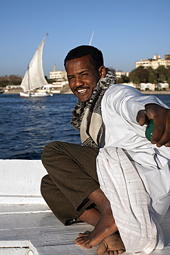 Man sailing felucca on the river Nile at Aswan, Egypt, North Africa, Africa