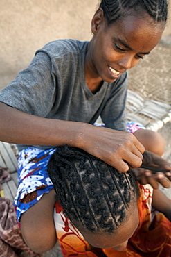 Girls plait their hair in traditional styles, Massawa, Eritrea, Africa