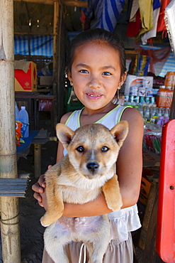 A young girl with her dog, Luang Prabang, Laos, Indochina, Southeast Asia, Asia