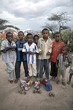 Children with home-made toys pose for a photograph in an Internally Displaced Persons camp in the city of Hargeisa, capital of Somaliland, Somalia, Africa